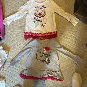 Two kids long sleeve shirts with rufffle bottoms.